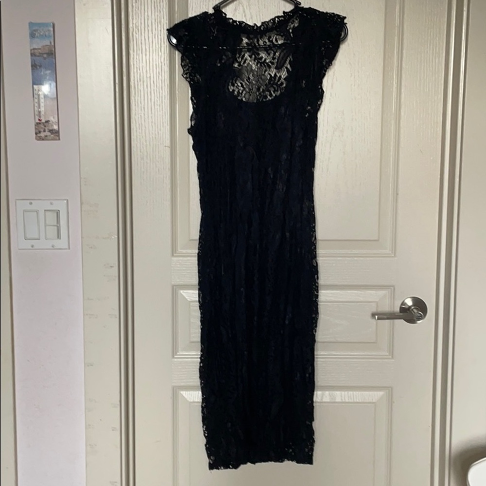 Black lace dress with ruffle sleeves.